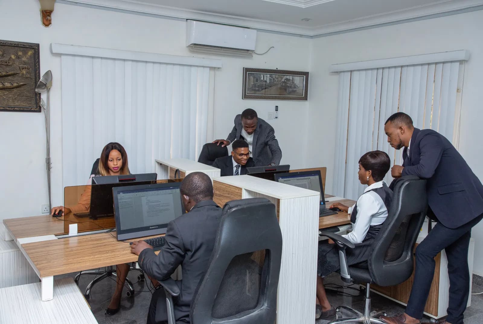 A team working through documents at their computers